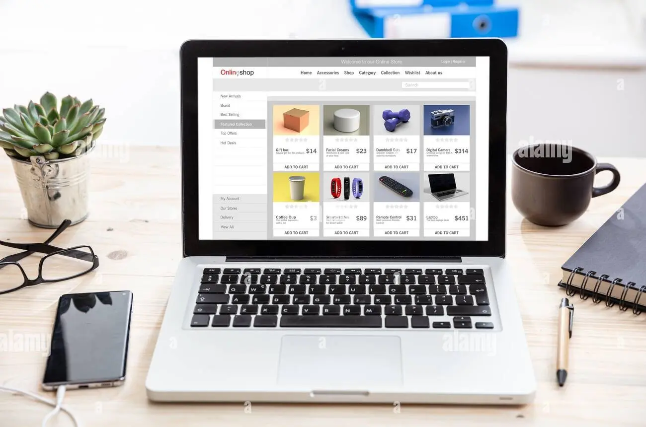 Laptop showing an online business website and digital workspace